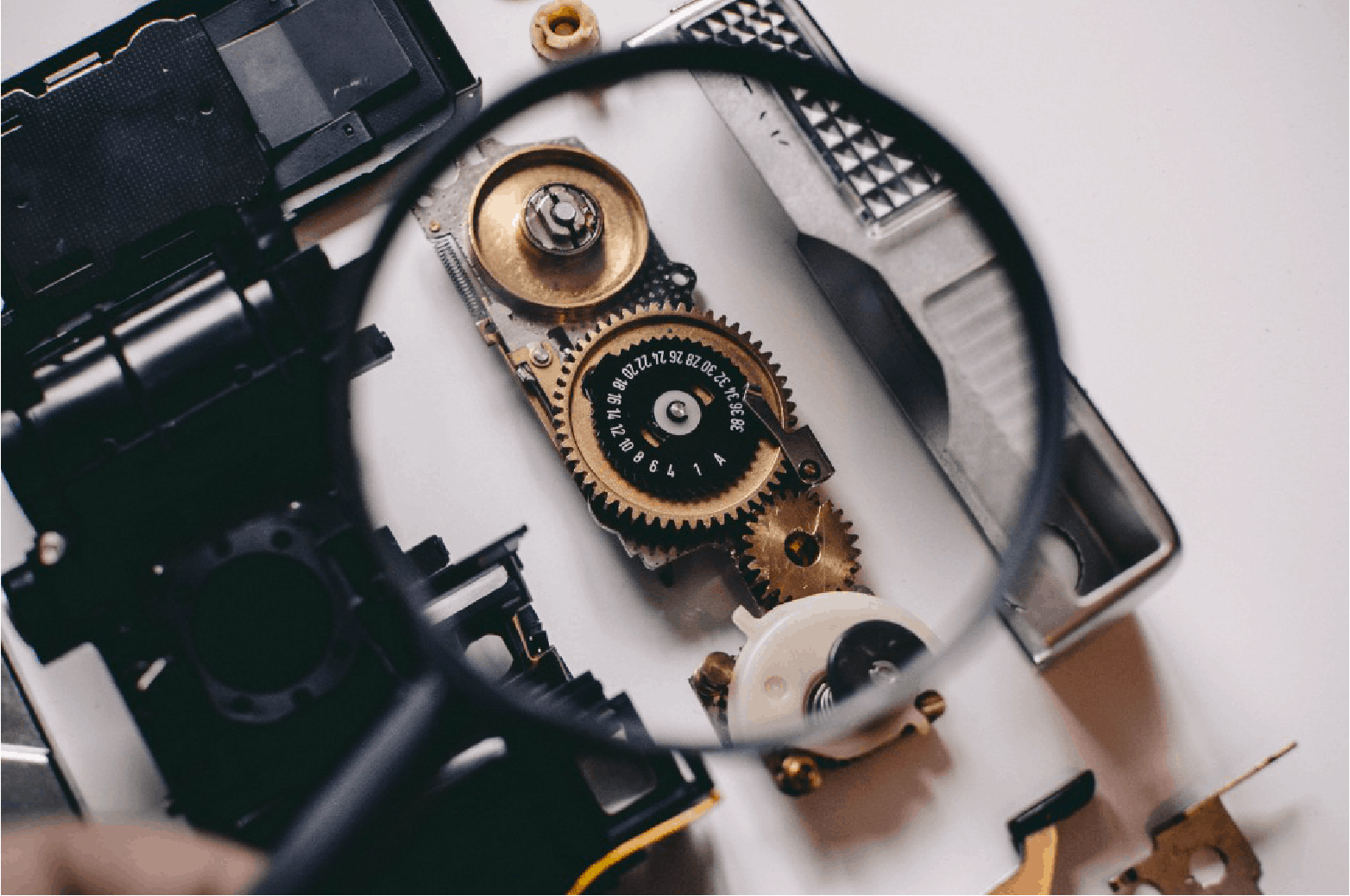 magnifying glass highlighting gears